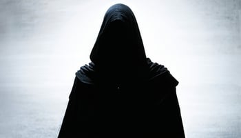 A mysterious and shadowy figure symbolizing the secrecy and intrigue surrounding the Illuminati.